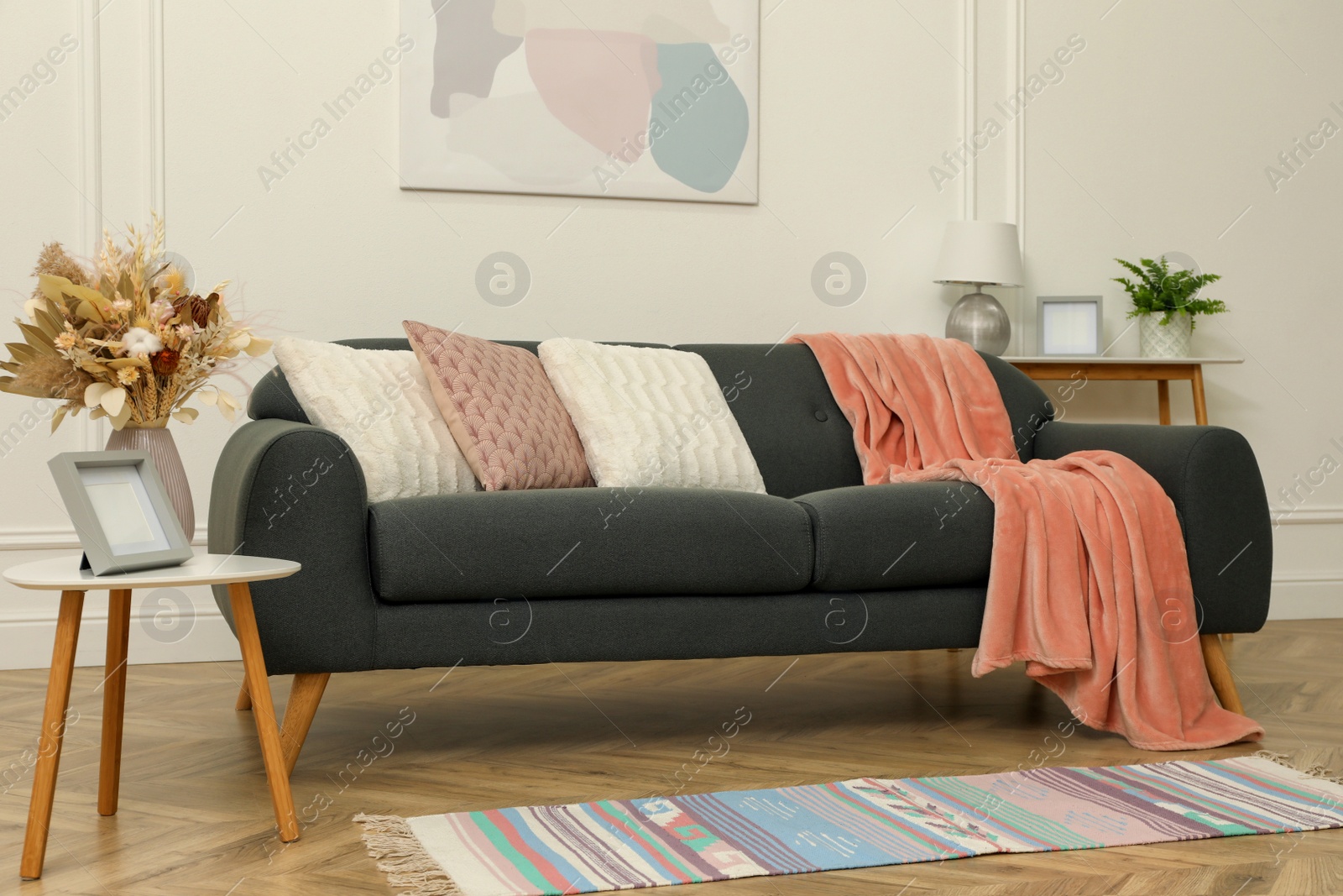 Photo of Beautiful sofa with cushions in living room. Interior design