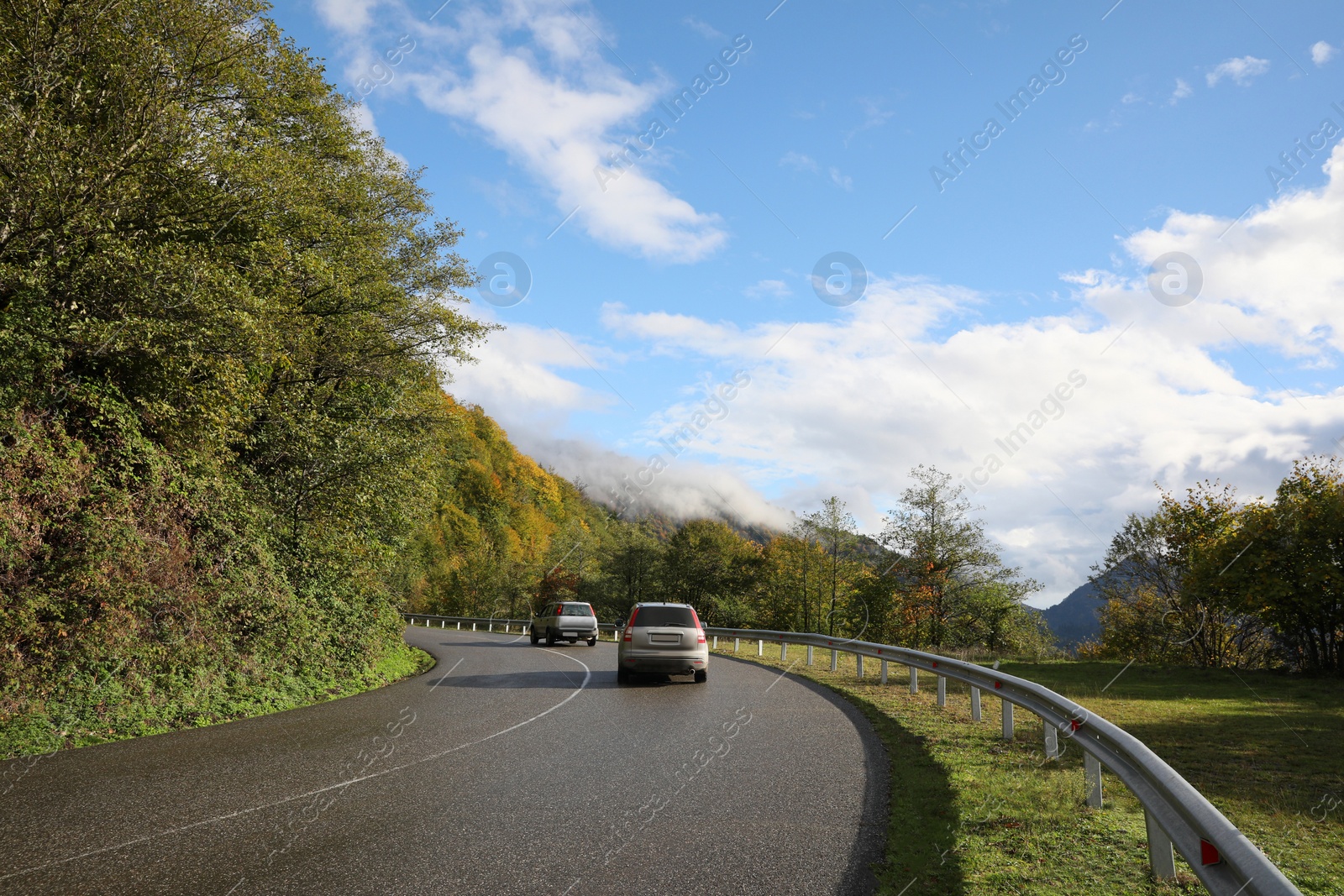 Photo of Picturesque view of road with cars in mountains