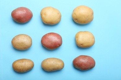 Flat lay composition with fresh organic potatoes on color background