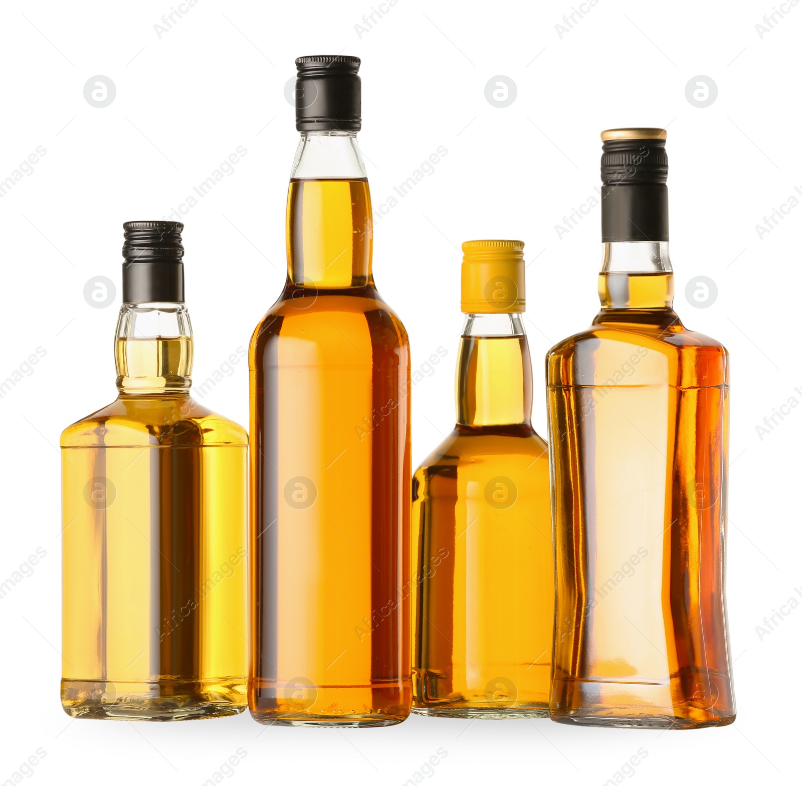 Photo of Different sorts of whiskey in glass bottles isolated on white