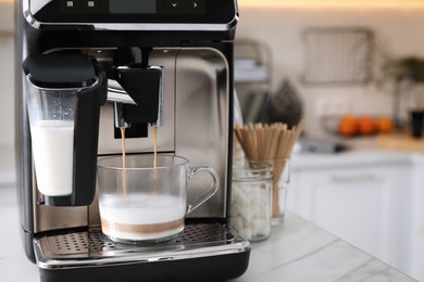 Photo of Modern coffee machine making tasty drink in office kitchen, space for text