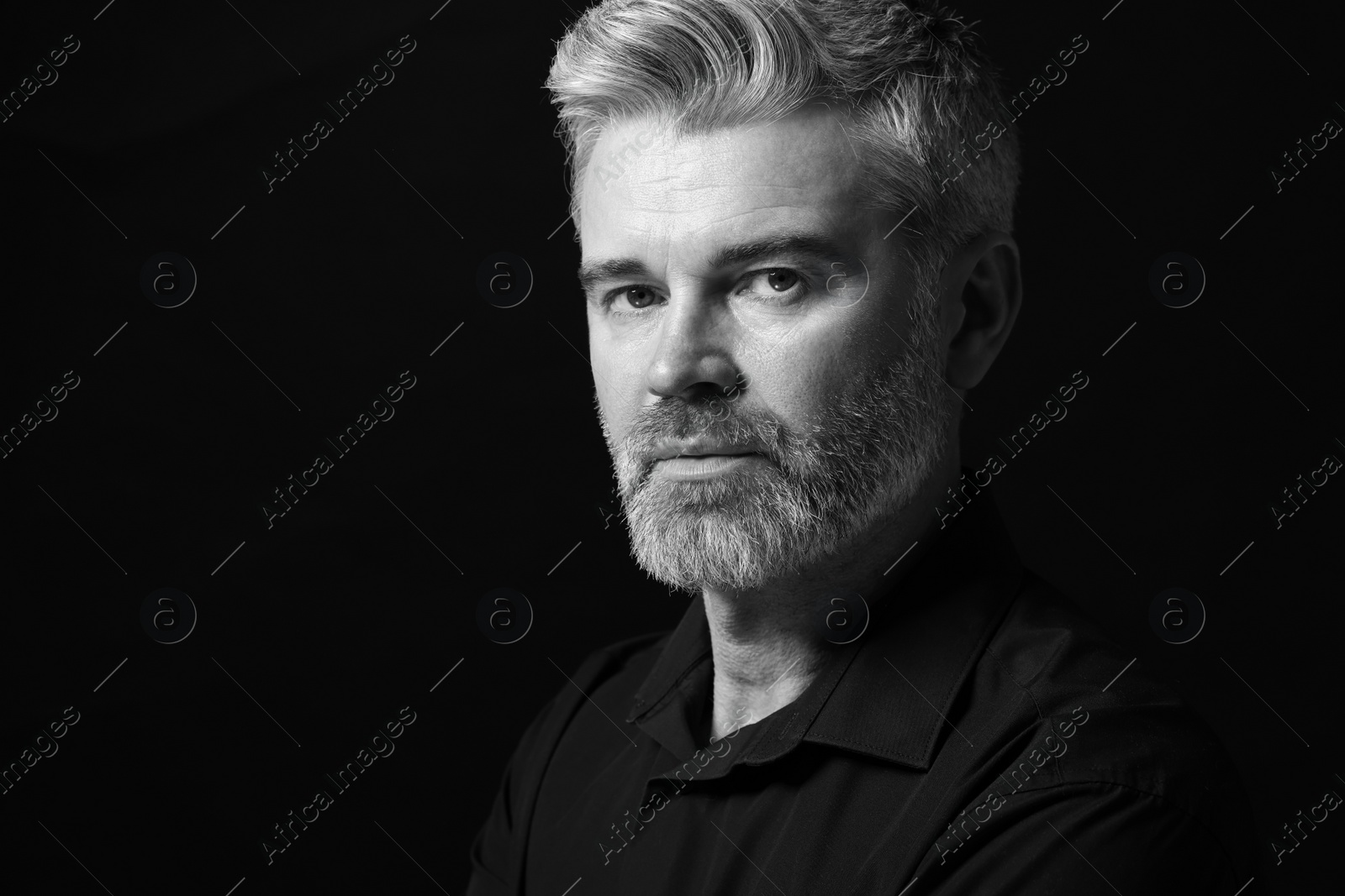 Photo of Portrait of handsome man on dark background, space for text. Black and white effect