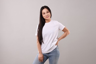 Woman wearing white t-shirt on light grey background