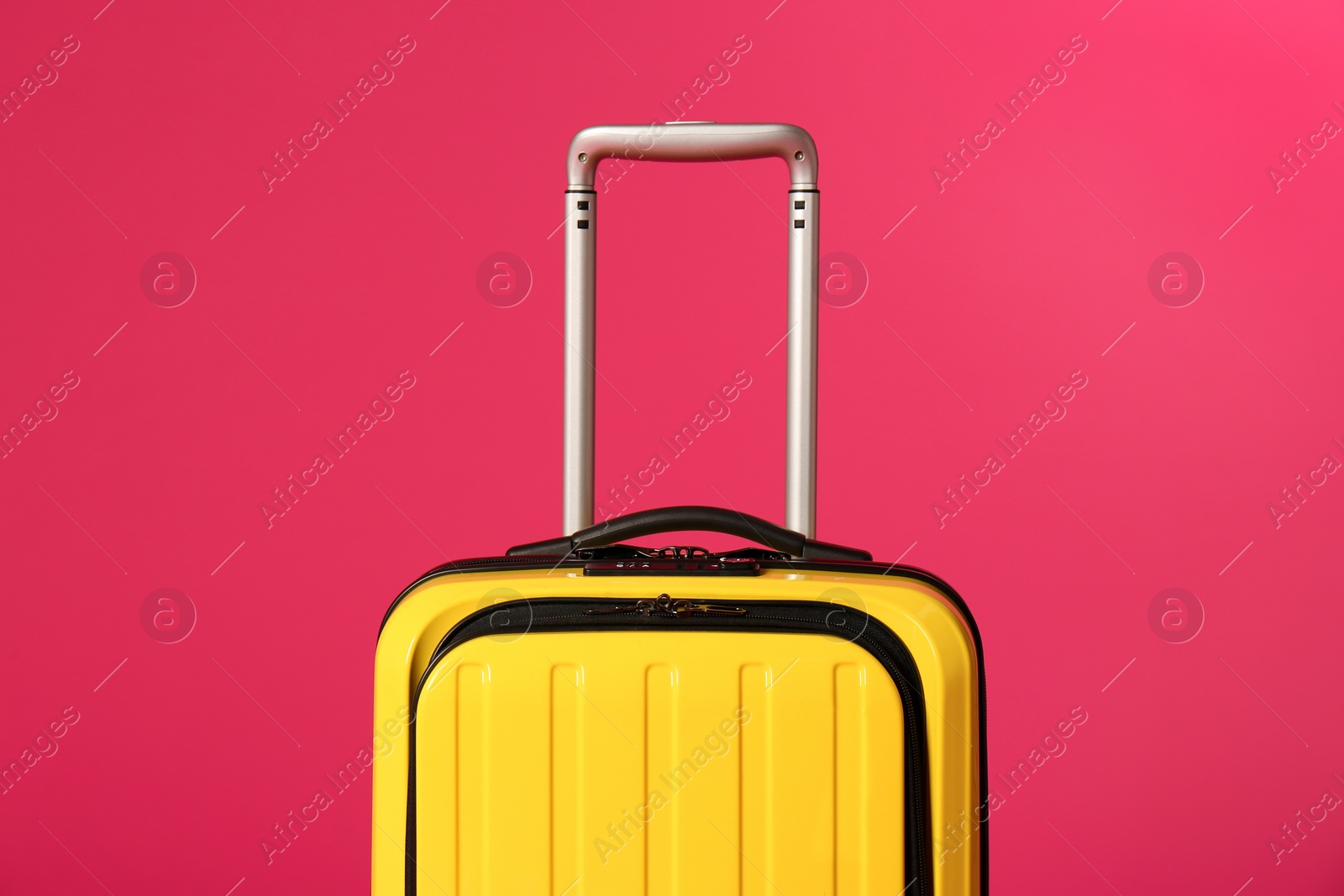 Photo of Stylish carry on suitcase on color background