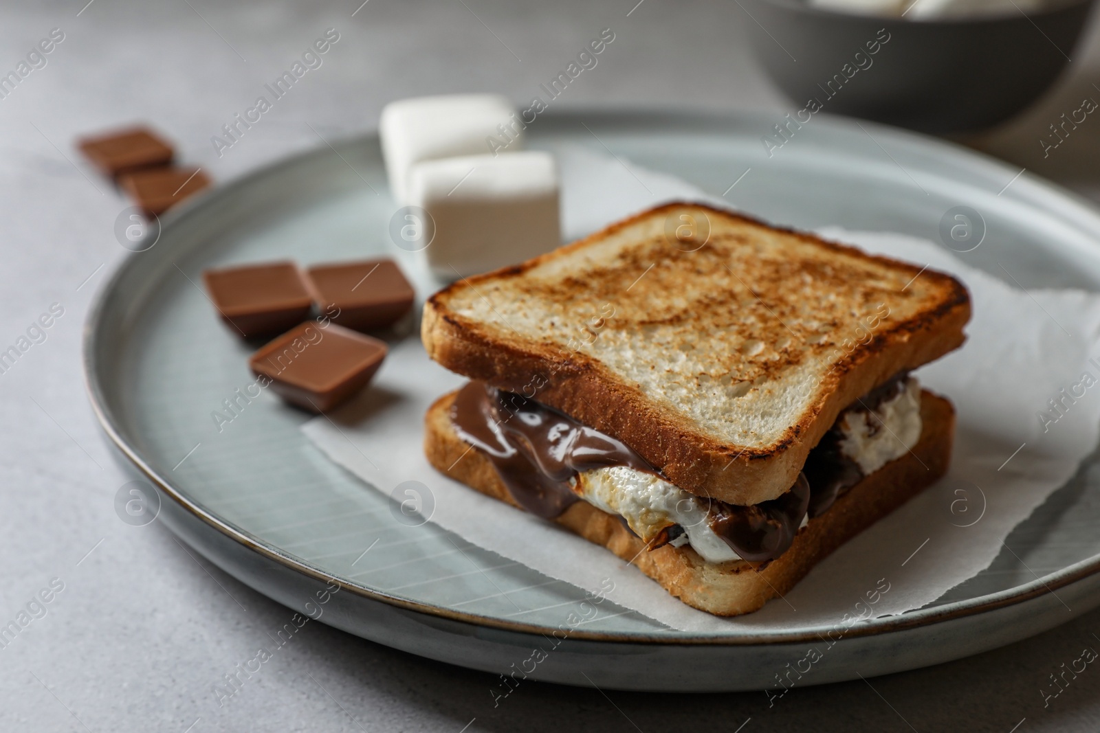 Photo of Delicious marshmallow sandwiches with bread and chocolate on wooden table, closeup