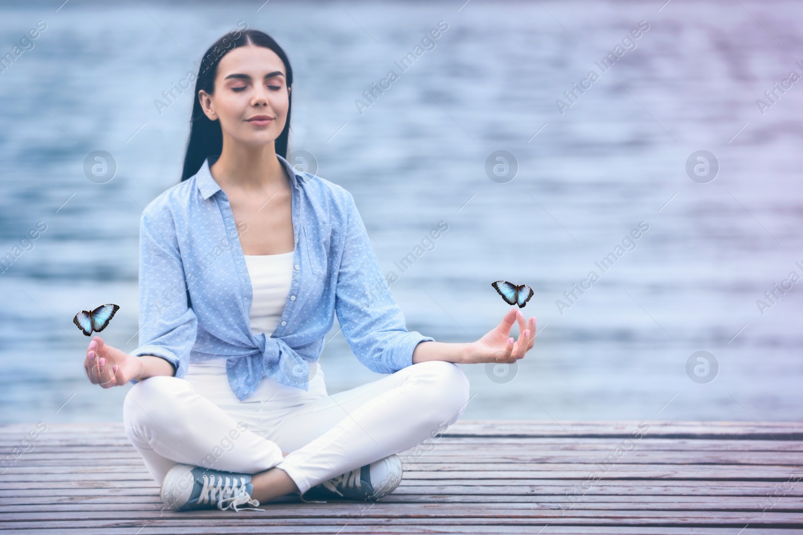 Image of Young woman meditating near river. Space for text