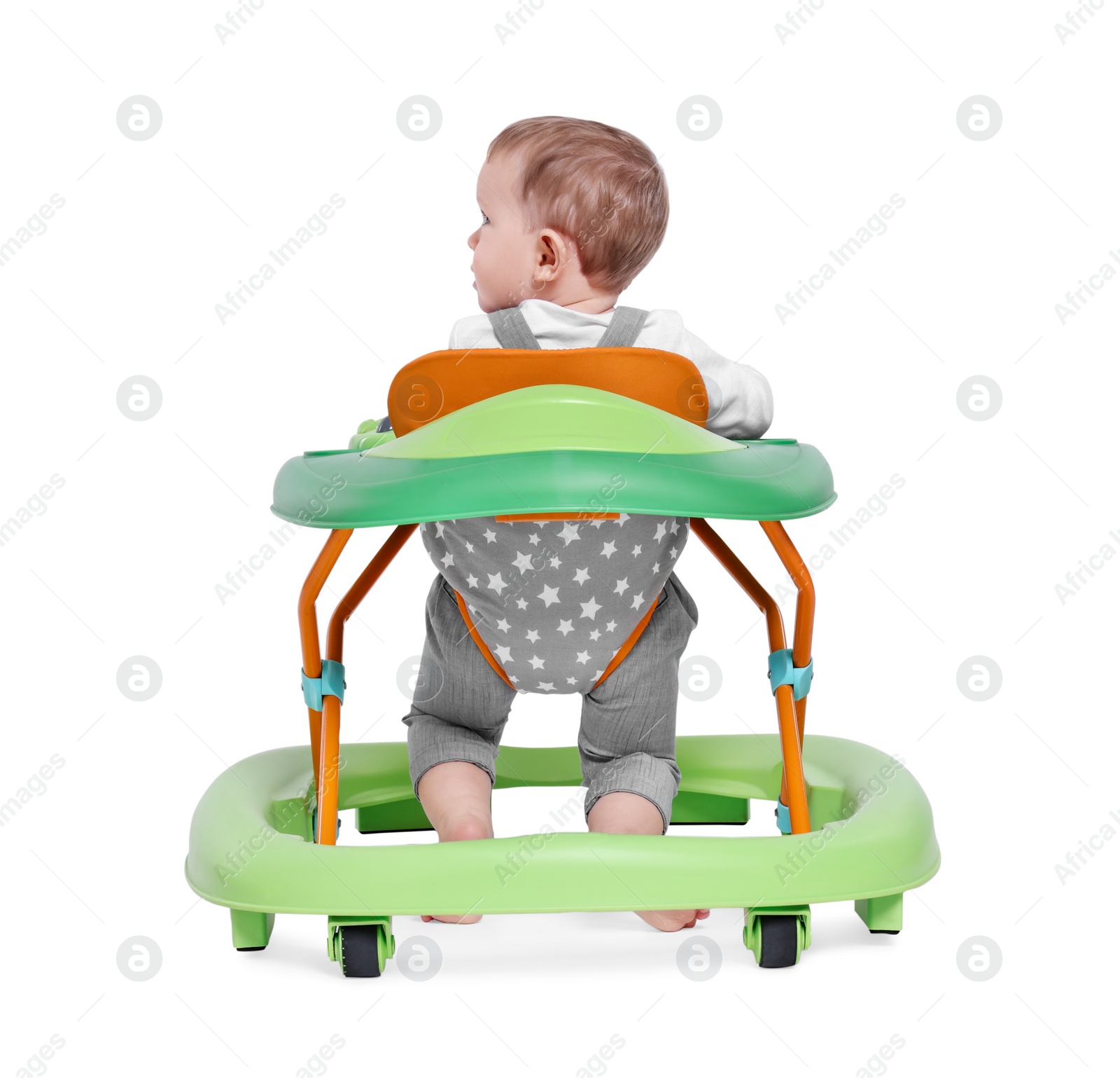 Photo of Cute little boy making first steps with baby walker on white background, back view