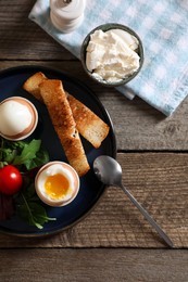 Delicious breakfast with soft boiled eggs served on wooden table, flat lay