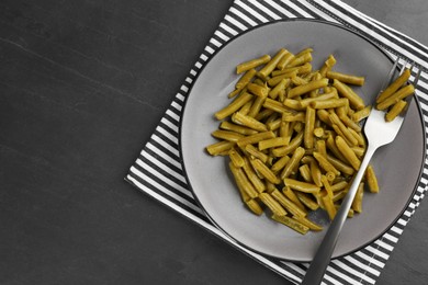 Canned green beans served on black table, top view