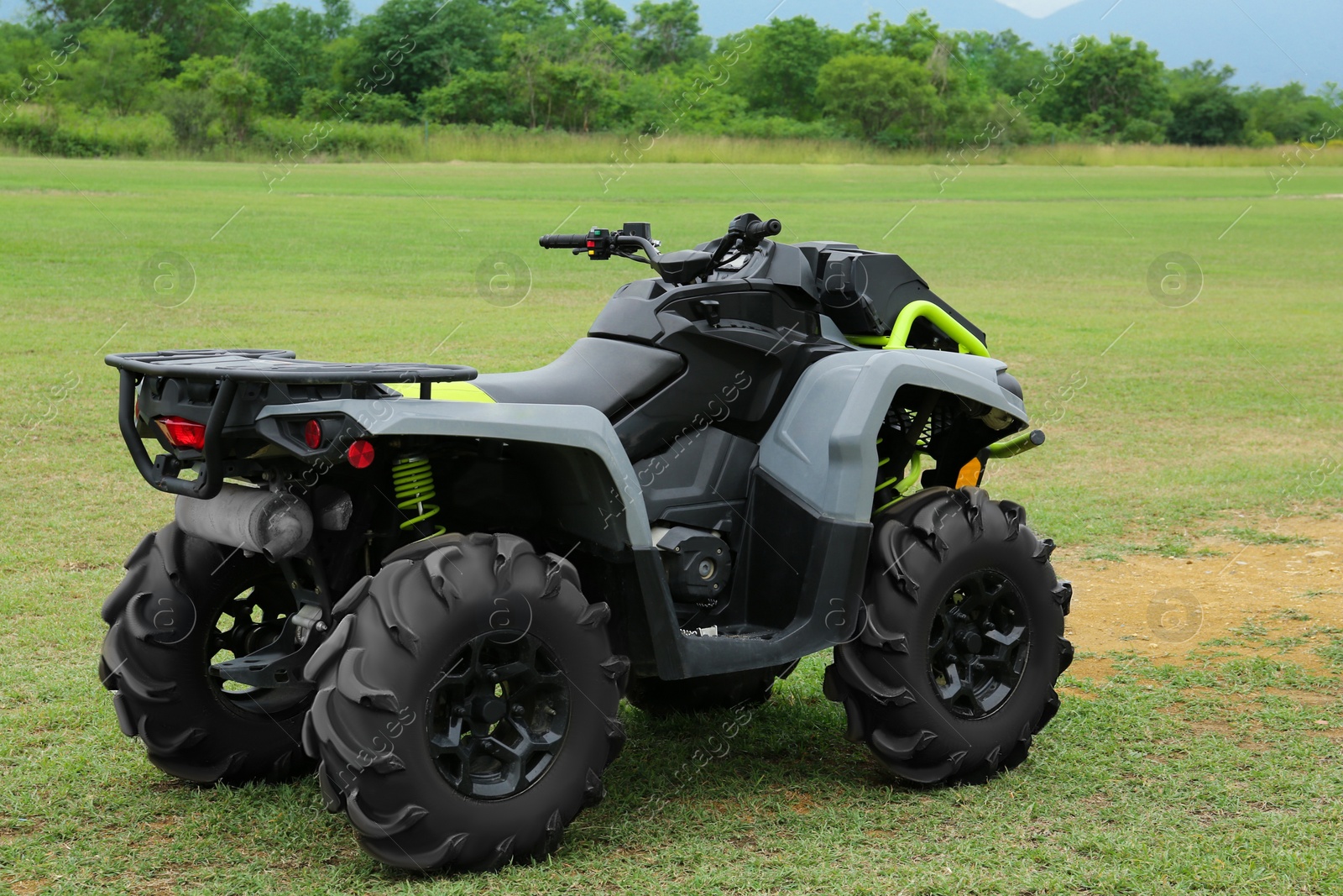 Photo of Modern quad bike on green grass outdoors