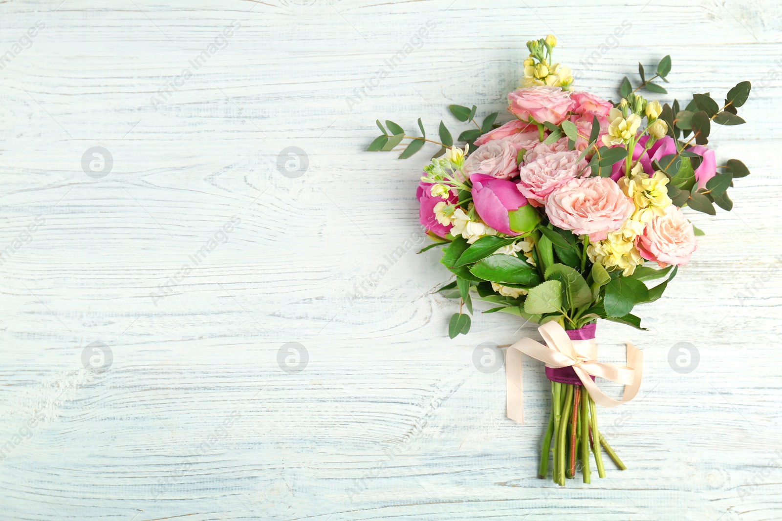 Photo of Bouquet of beautiful fragrant flowers on wooden background