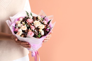 Photo of Woman with beautiful food bouquet on brown background, closeup. Space for text