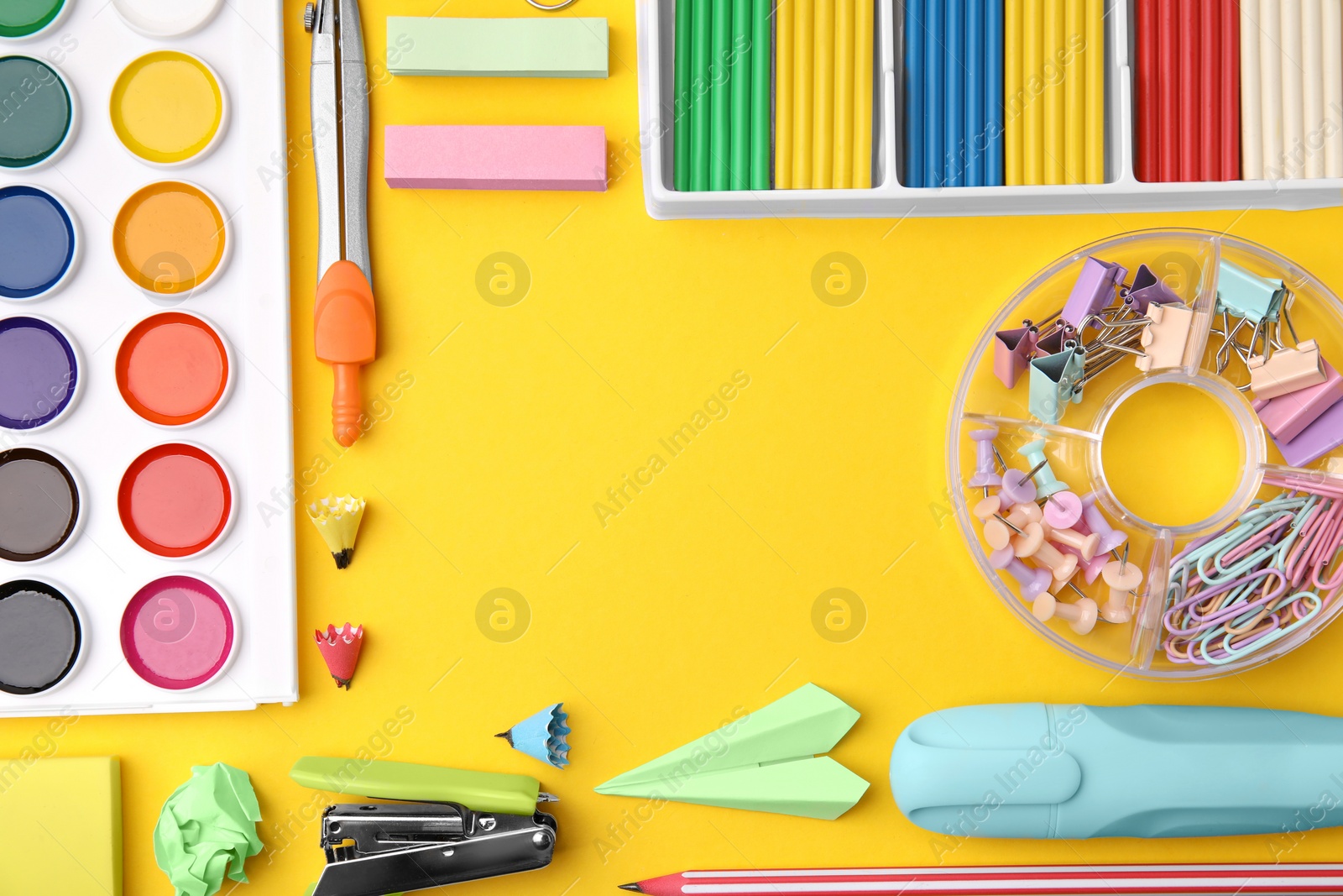 Photo of Flat lay composition with different school stationery on yellow background, space for text. Back to school