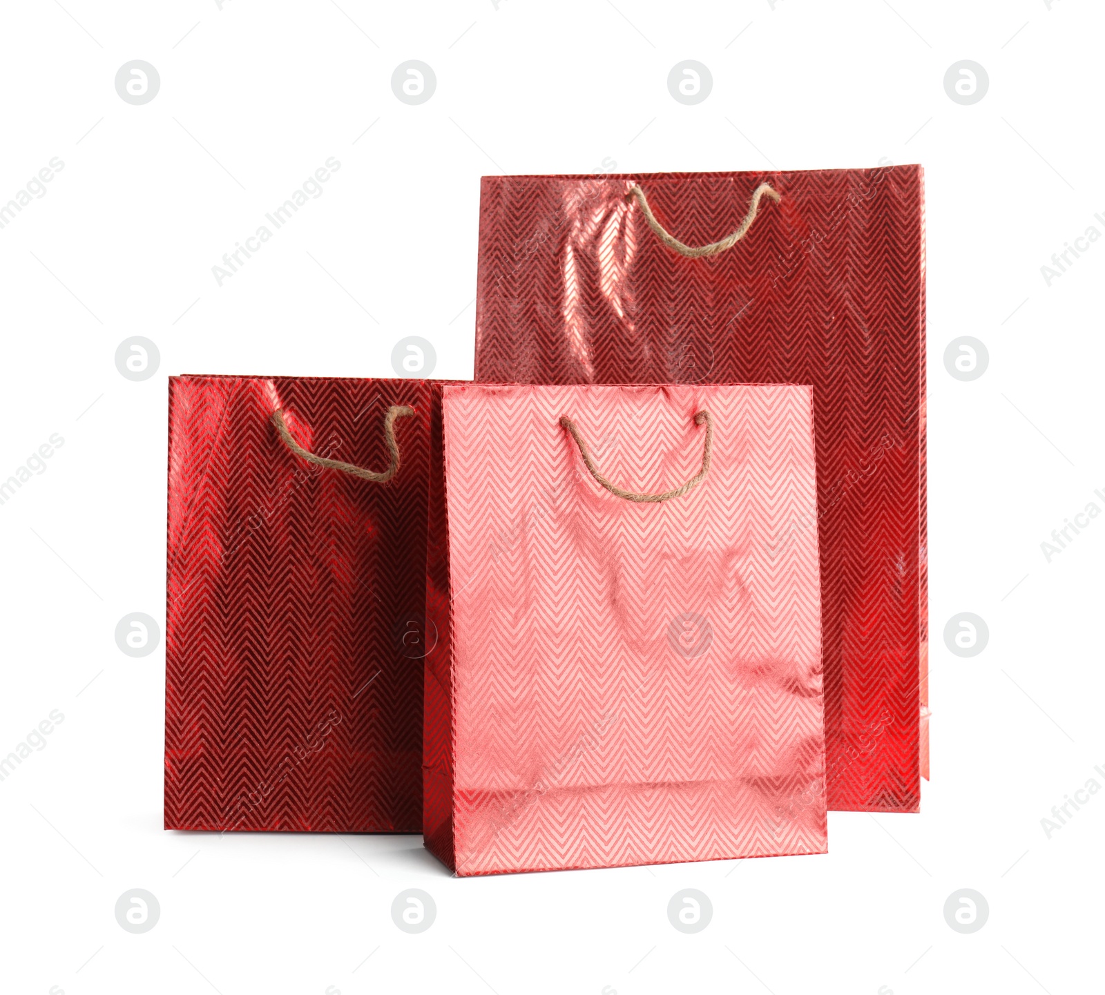 Photo of Red paper shopping bags isolated on white. Space for design