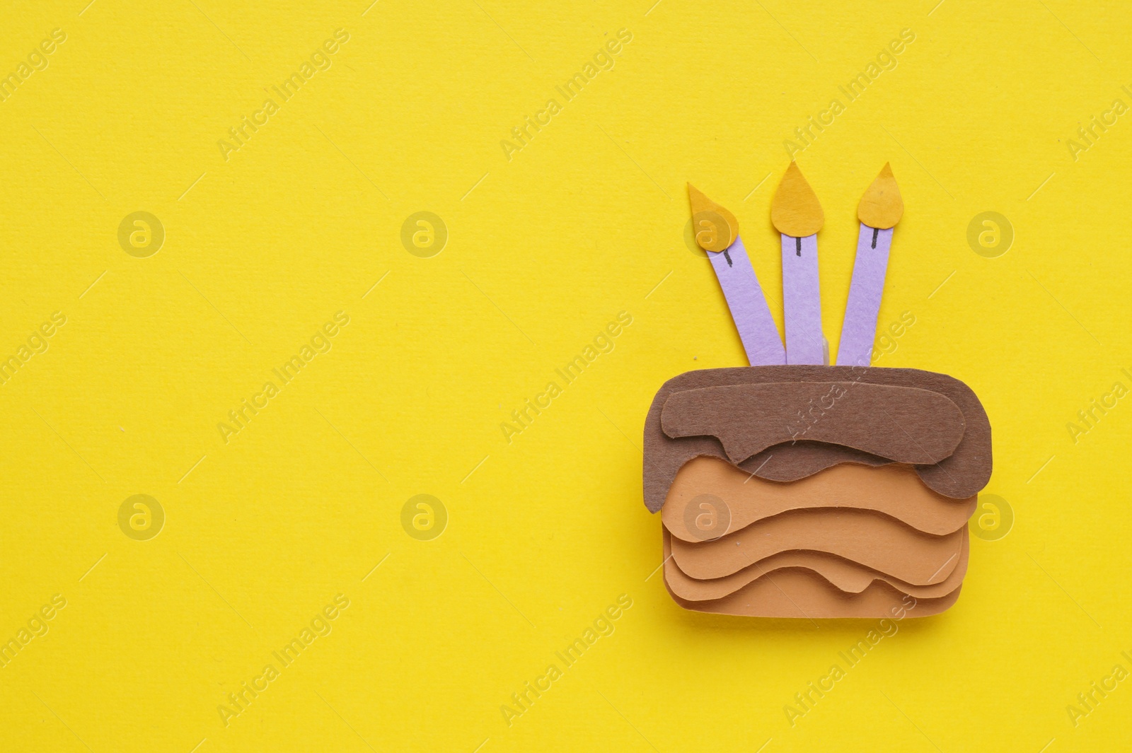 Photo of Birthday party. Paper cake on yellow background, top view. Space for text