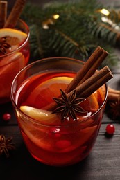 Photo of Glass with delicious punch drink on wooden table