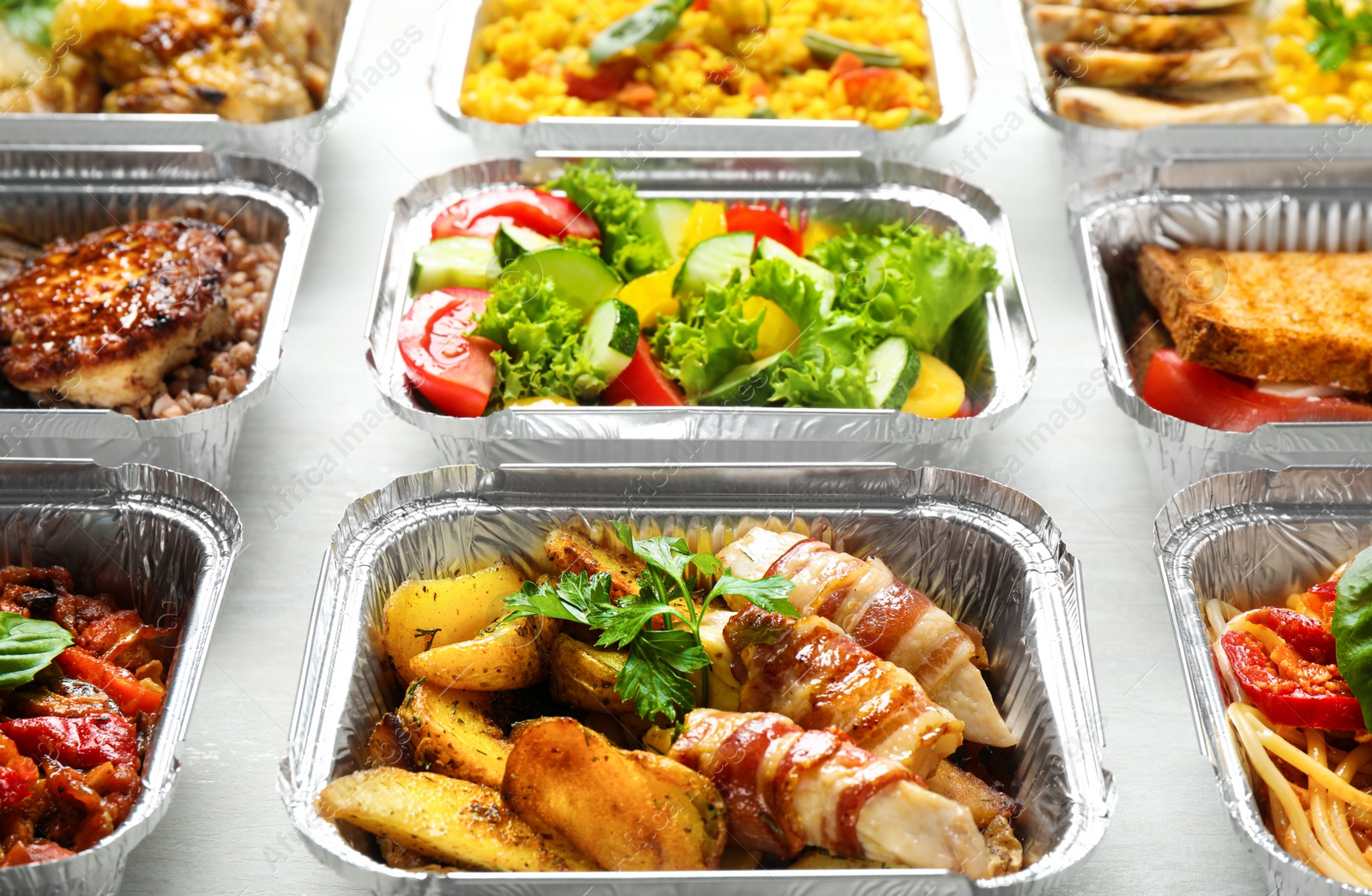 Photo of Lunchboxes on white wooden table. Healthy food delivery