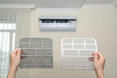 Image of Man holding dirty and clean filters, closeup. Home air conditioner cleaning