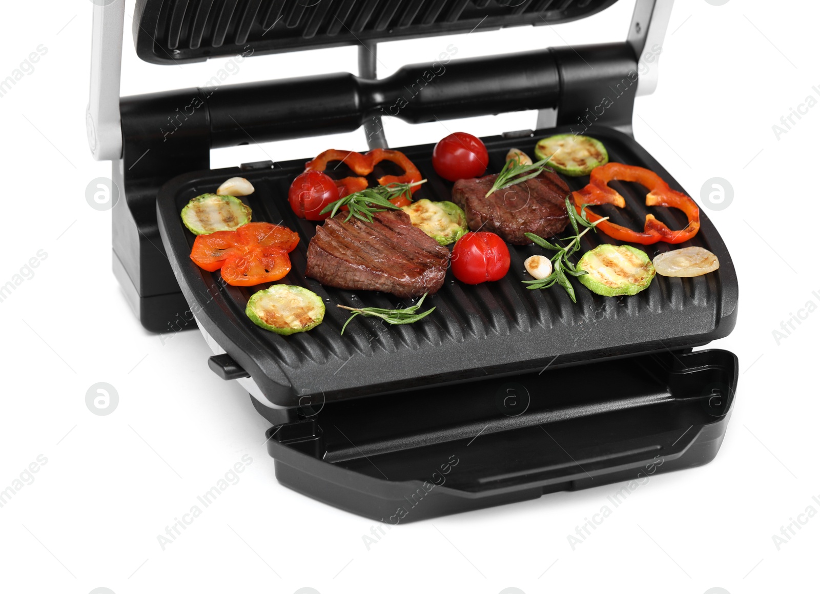 Photo of Electric grill with tasty meat, rosemary and vegetables isolated on white