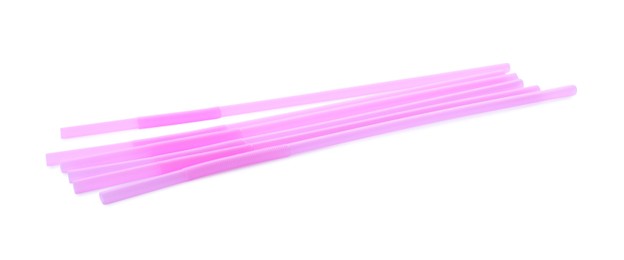 Light pink plastic cocktail straws on white background