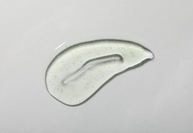 Photo of Sample of cosmetic gel on white background, top view