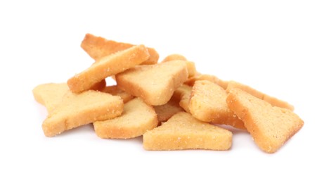 Pile of delicious crispy rusks on white background