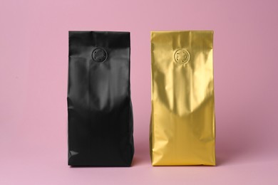 Photo of Different blank foil packages on pink background