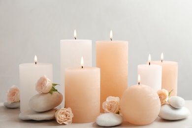 Photo of Beautiful composition with candles on table against grey background