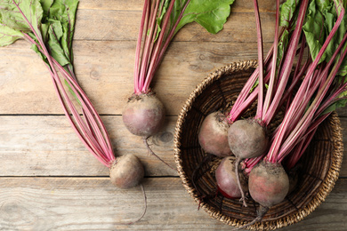 Photo of Raw ripe beets on wooden table, flat lay