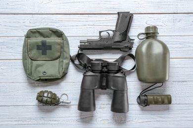 Set of military outfit on wooden background, flat lay