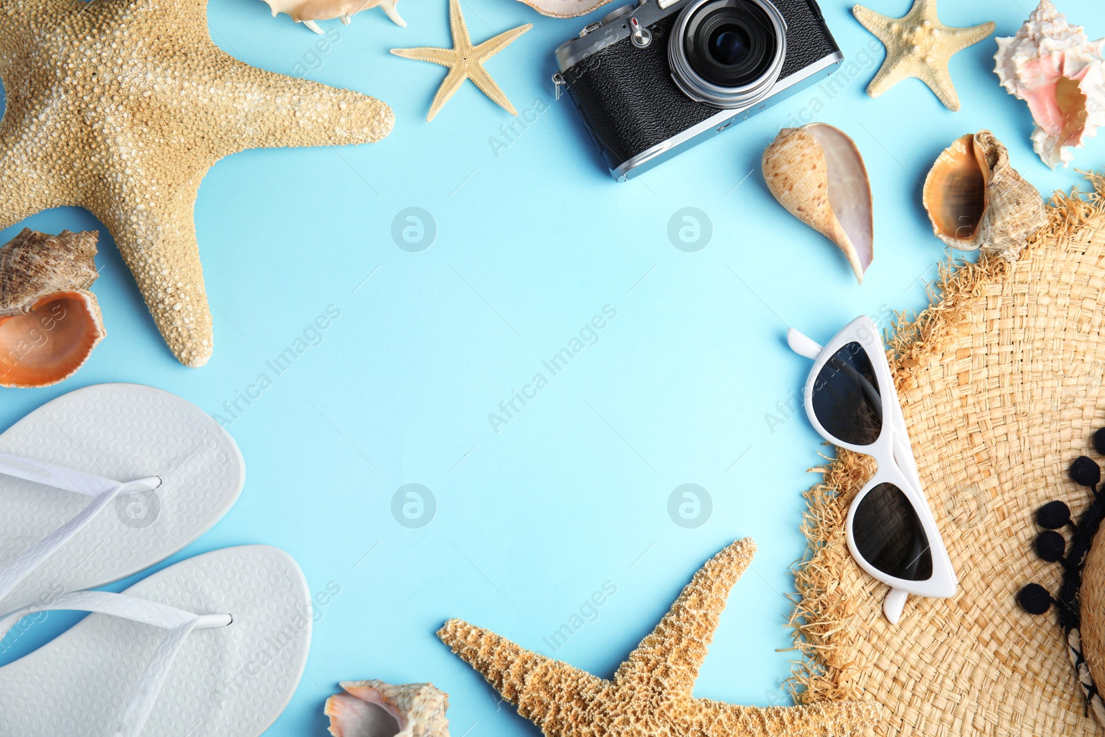 Photo of Flat lay composition with beach objects on blue background. Space for text