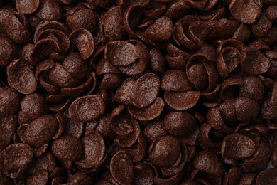 Photo of Breakfast cereal. Tasty chocolate corn flakes as background, top view