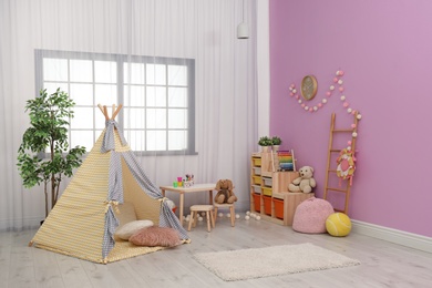 Modern nursery room interior with play tent for kids