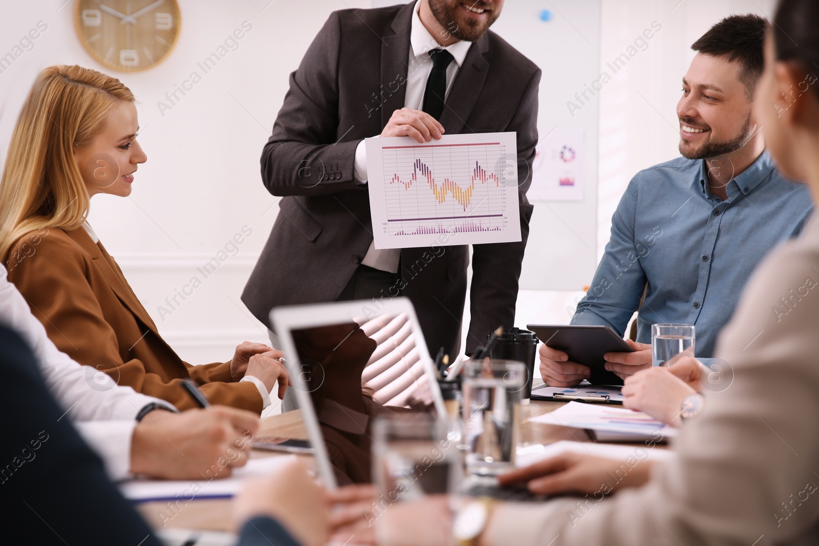 Photo of Businesspeople having meeting in office. Management consulting