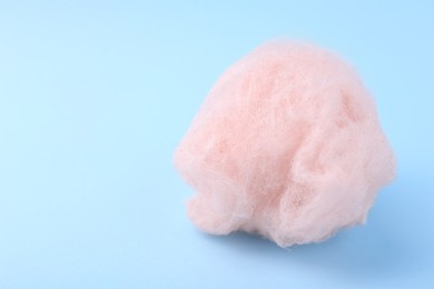 One sweet cotton candy on light blue background. Space for text