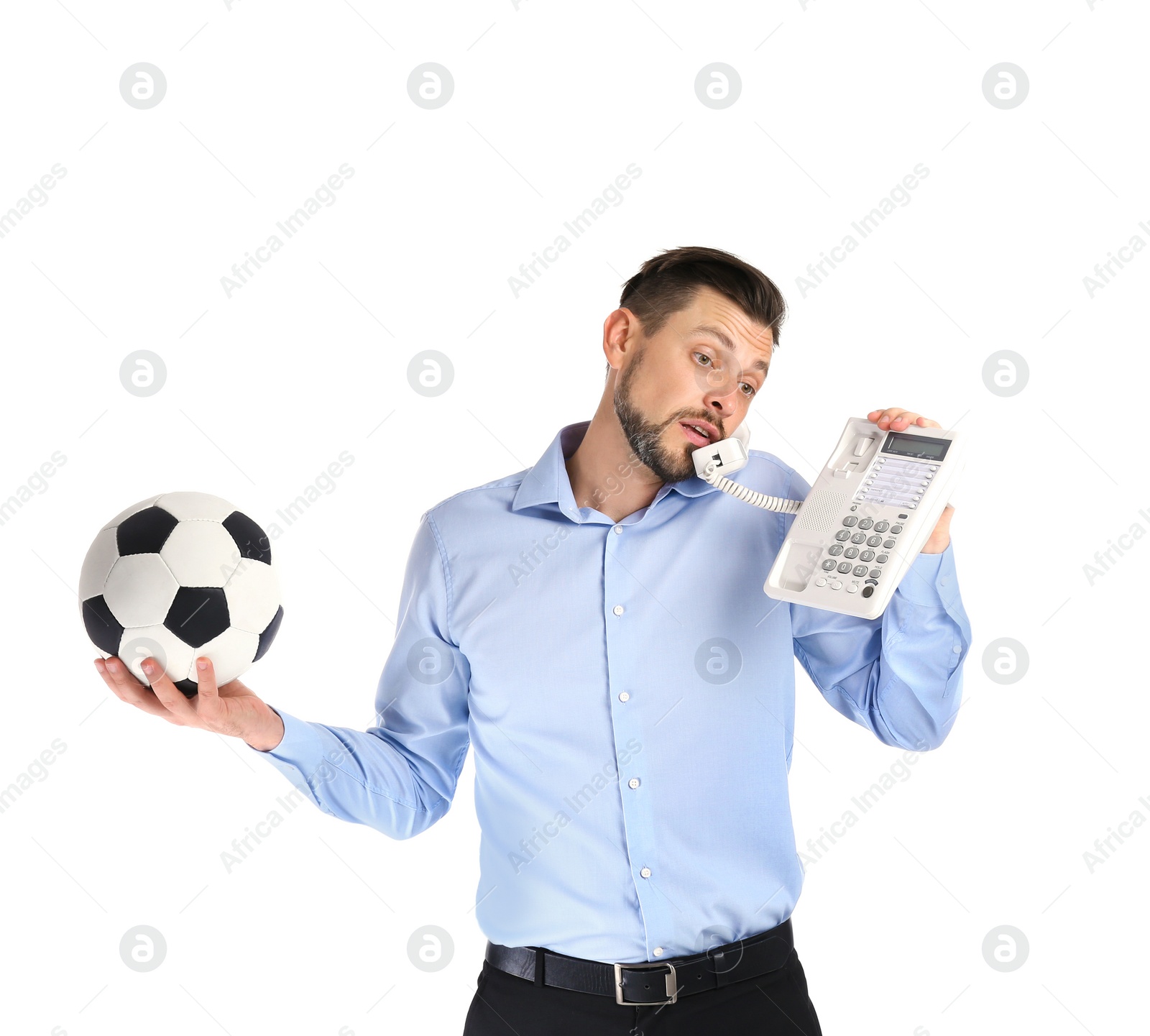 Photo of Businessman holding soccer ball while talking on phone against white background. Combining life and work