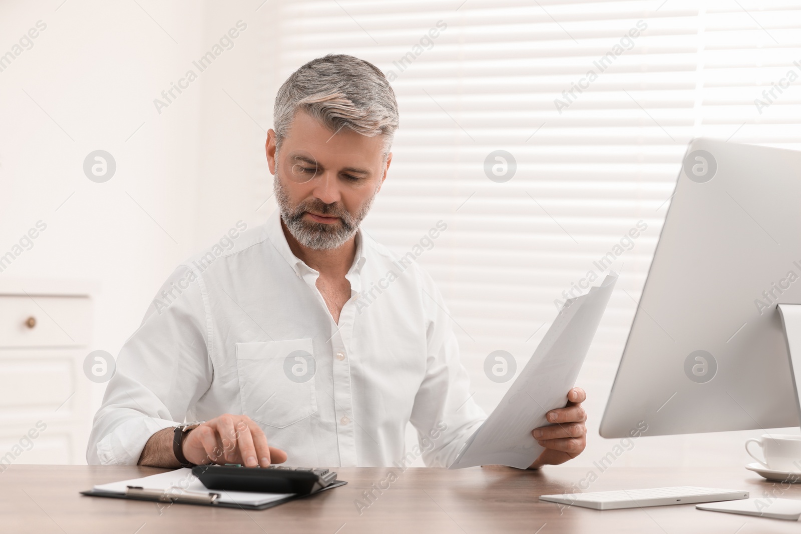 Photo of Professional accountant working at wooden desk in office