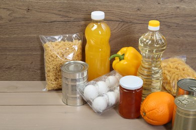 Many different donation food on wooden table