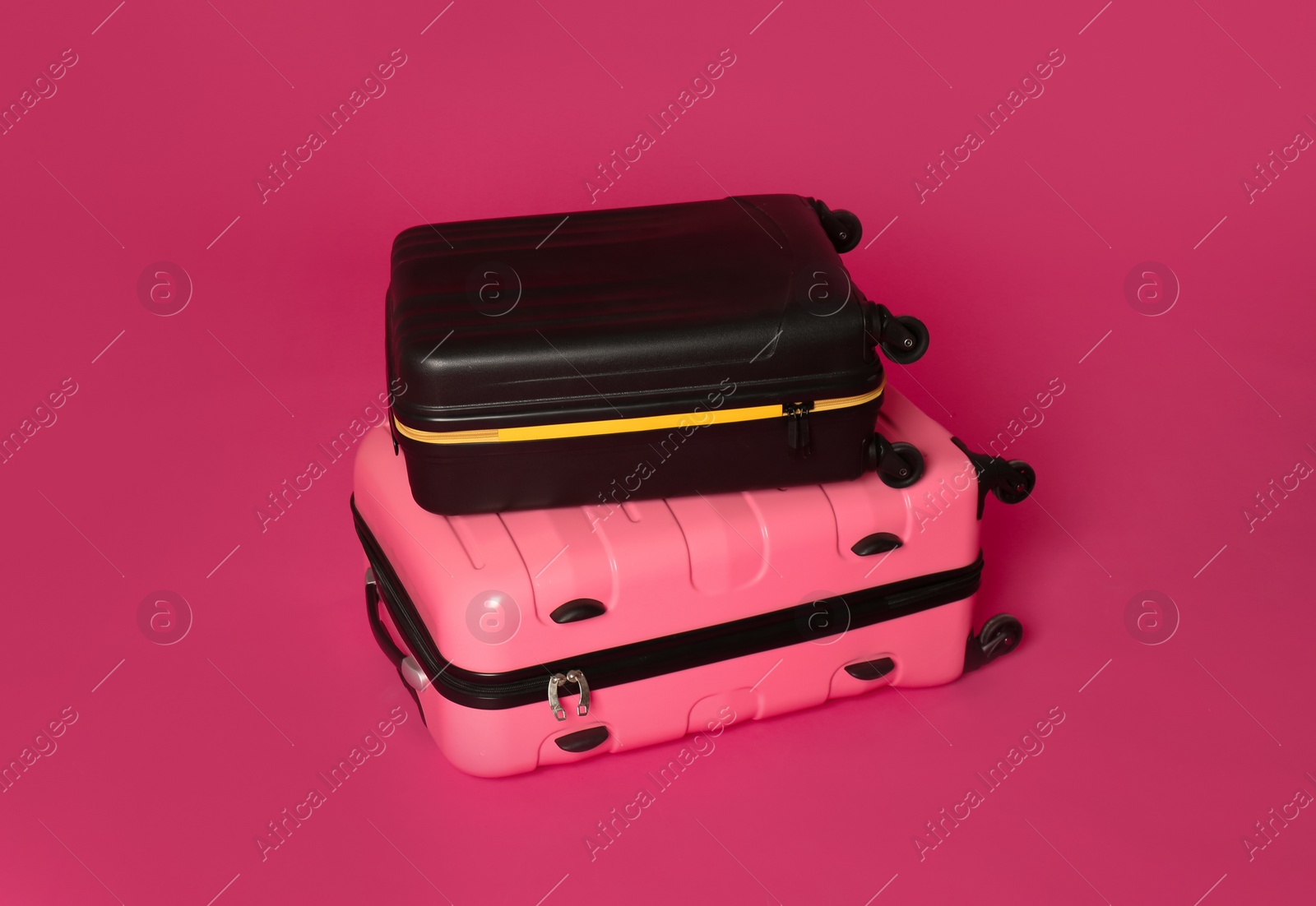 Photo of Stylish carry on suitcases on color background