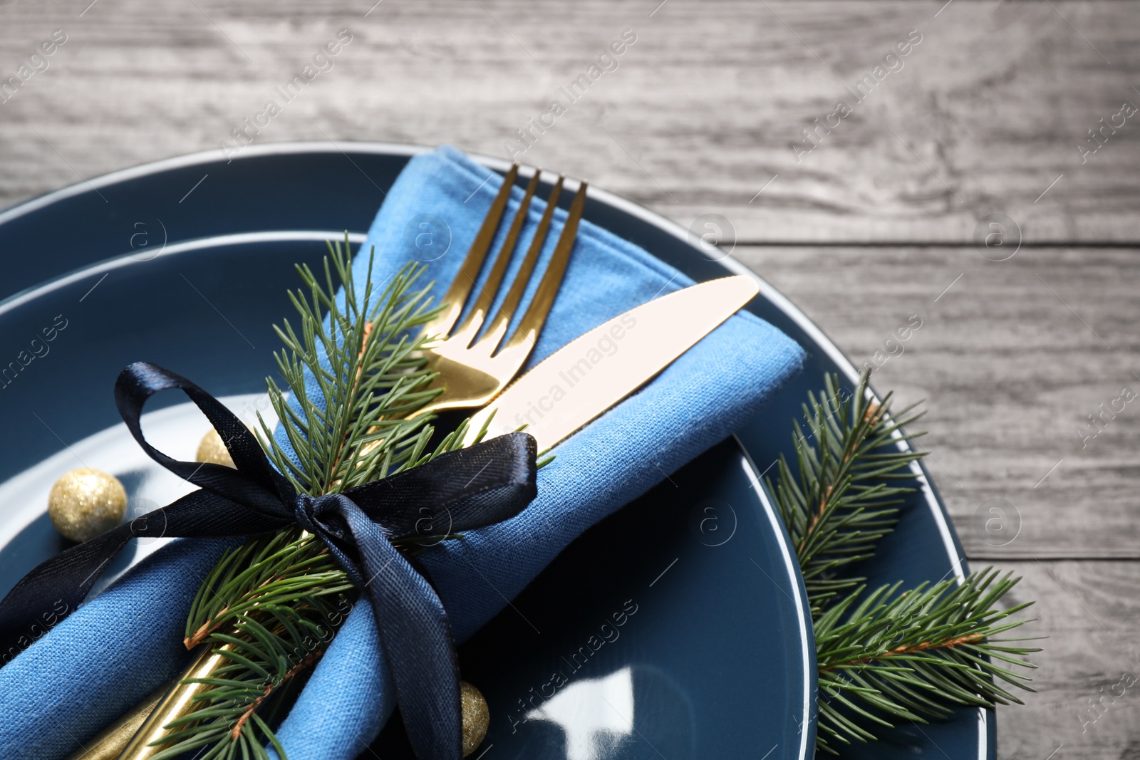 Photo of Christmas table setting on grey wooden background, closeup