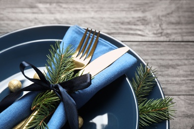 Photo of Christmas table setting on grey wooden background, closeup