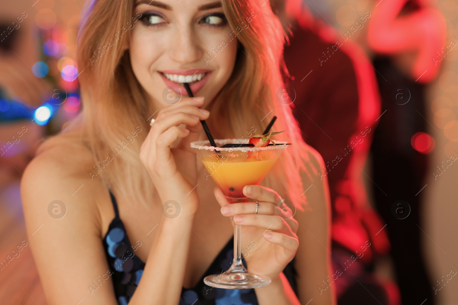 Photo of Beautiful young woman with glass of martini cocktail at party