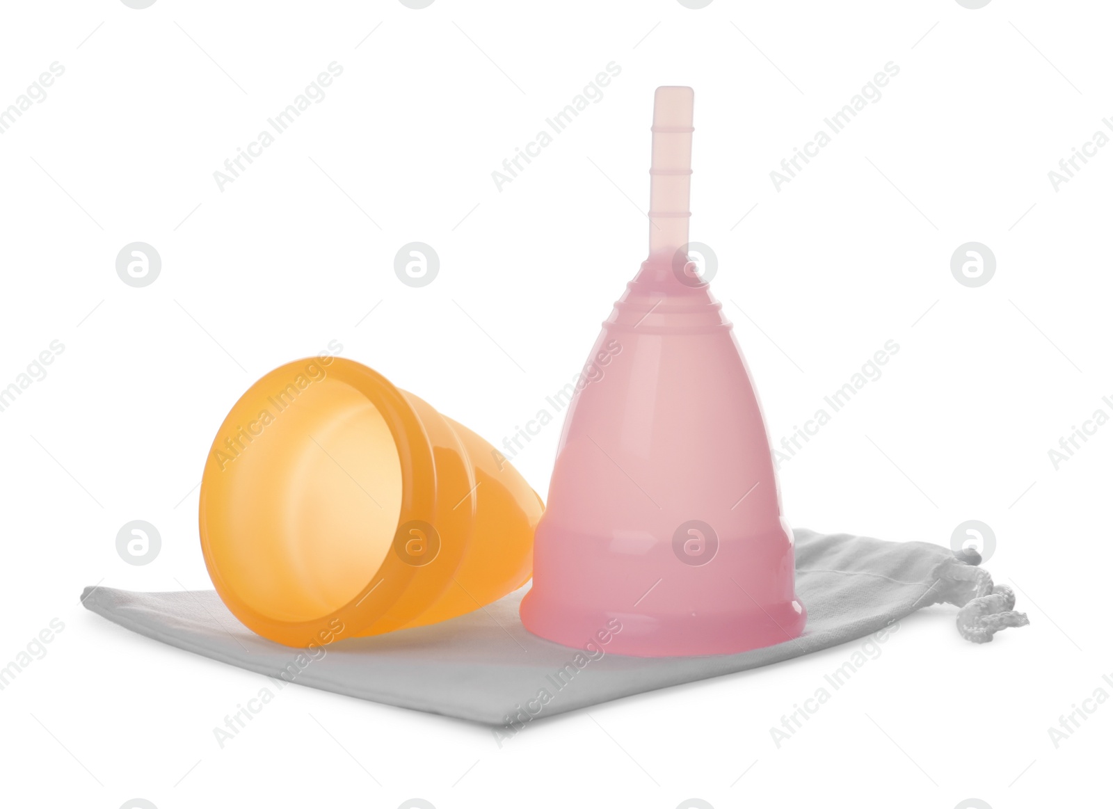 Photo of Menstrual cups with cotton bag isolated on white. Reusable feminine hygiene product