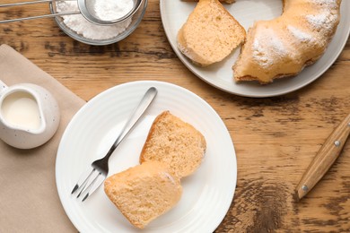 Photo of Delicious sponge cake served on wooden table, flat lay