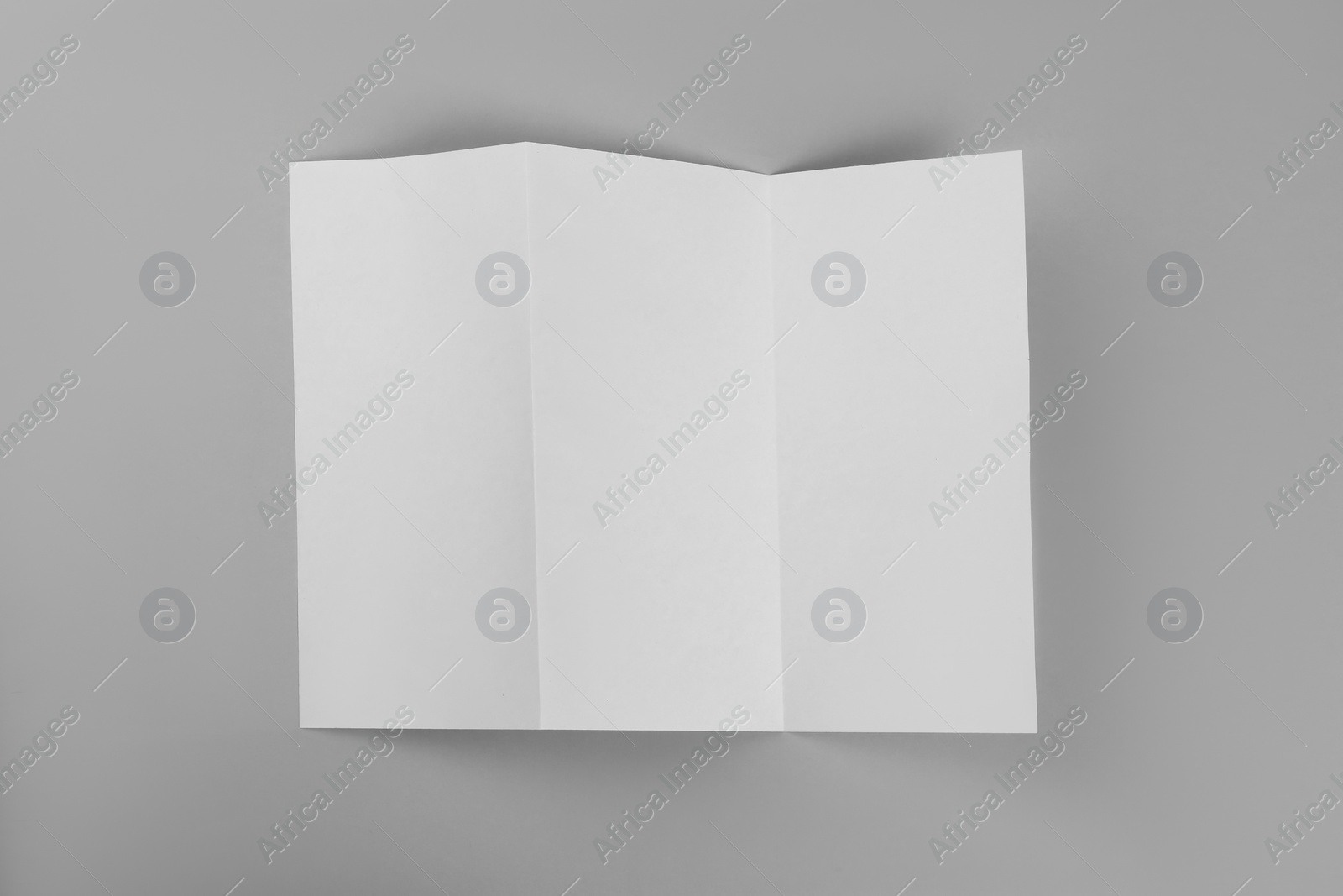 Photo of Blank paper brochure on light grey background, top view. Mockup for design