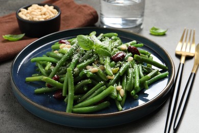 Photo of Tasty salad with green beans served on grey table