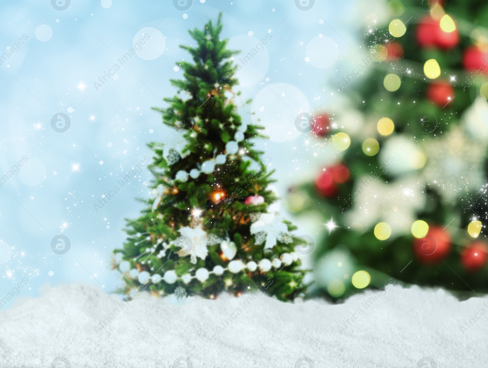 Image of Snow and beautiful decorated Christmas tree. Bokeh effect