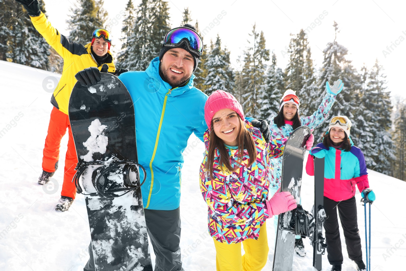 Photo of Group of friends with equipment in snowy mountains. Winter vacation