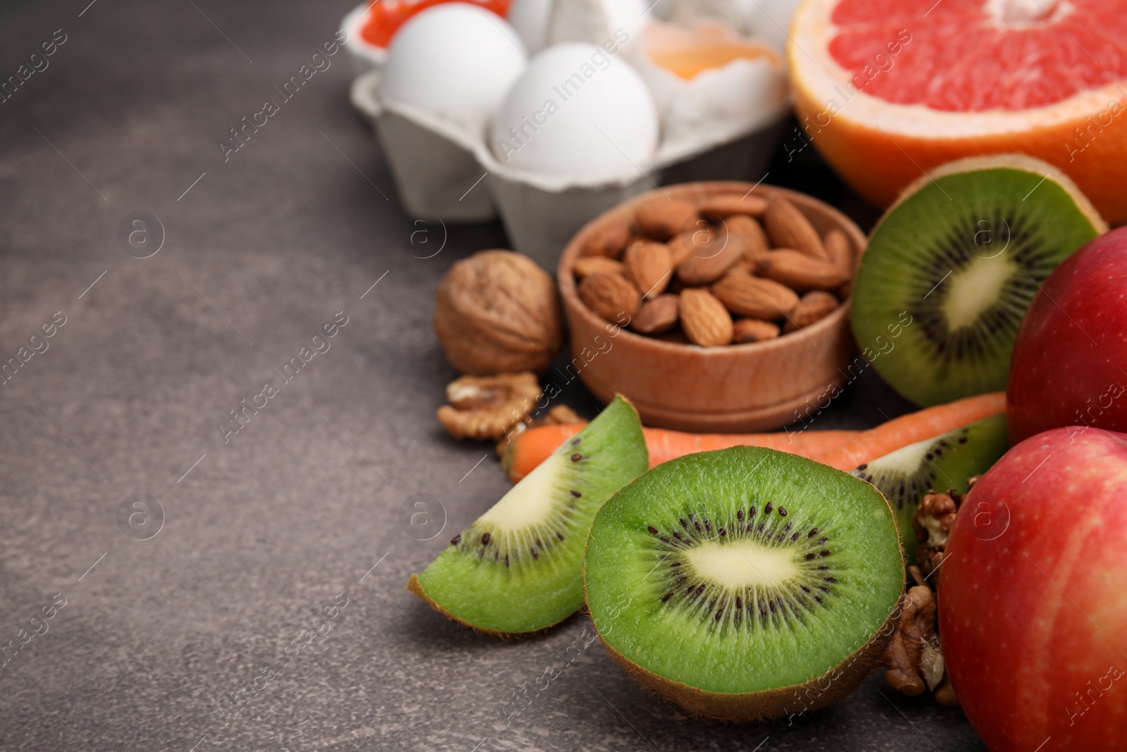 Photo of Natural sources of serotonin. Many different products on brown table, closeup. Space for text