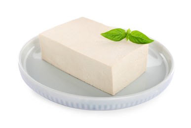 Photo of Plate with delicious raw tofu and basil isolated on white